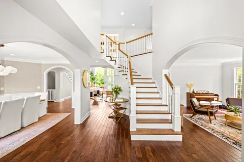 a view of a living room with furniture and wooden floor