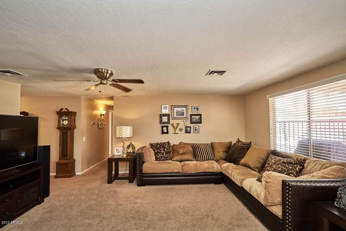 1722 West Colt Road Chandler, AZ 85224 - Photo 4 of 29 a living room with furniture and a flat screen tv