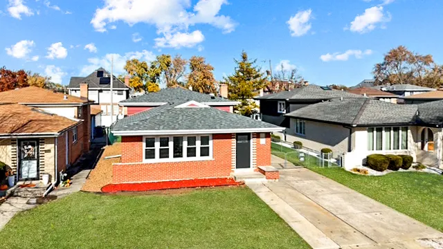 a view of a house with a swimming pool and a yard