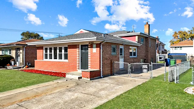 a front view of a house with a yard table and chairs