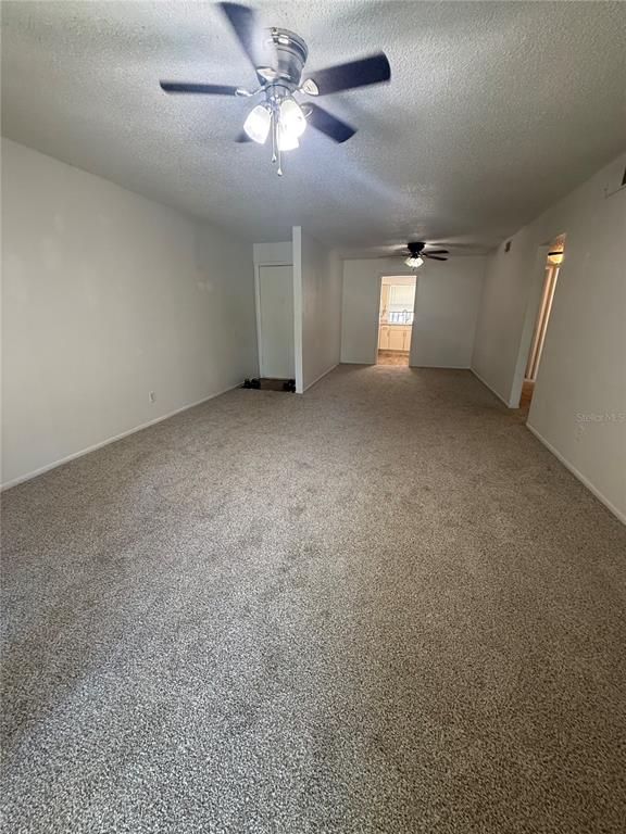 7667 Abonado Road, Unit 7667 Tampa, FL 33615 - Photo 2 of 15 an empty room with chandelier fan and windows