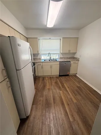 a room with wooden floors and white walls