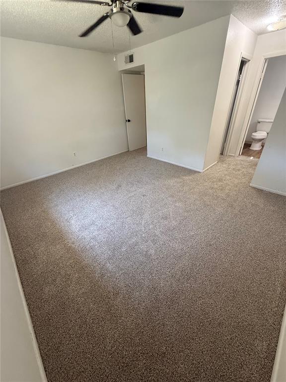 7667 Abonado Road, Unit 7667 Tampa, FL 33615 - Photo 7 of 15 an empty room with a ceiling fan and carpet