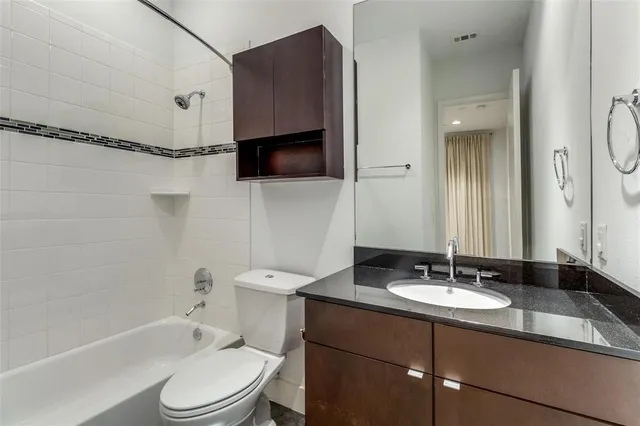 a bathroom with a sink toilet a mirror and shower