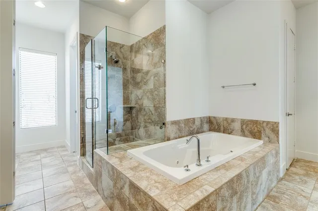 a bathroom with a bath tub and shower