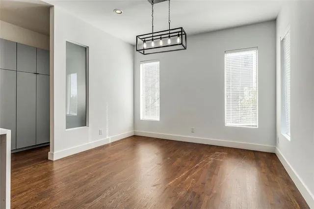a view of a room with wooden floor and window
