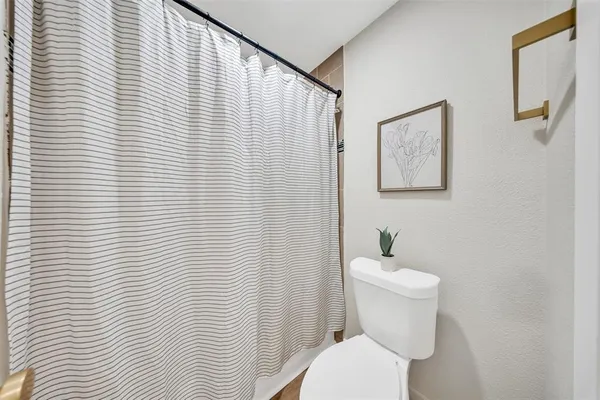 a white toilet sitting next to a white wooden roof