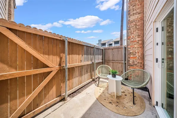 a backyard of a house with table and chairs