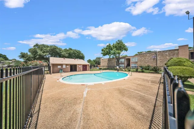 a view of a swimming pool with a patio