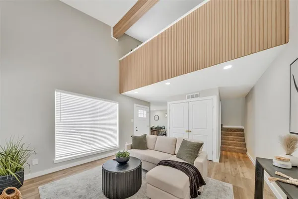 a living room with furniture and a potted plant
