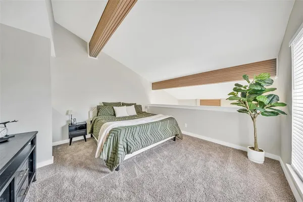 a bedroom with a bed and a potted plant