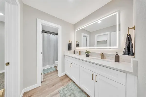 a bathroom with a double vanity sink and a mirror