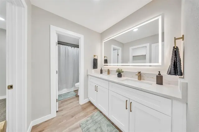 a bathroom with a double vanity sink and a mirror
