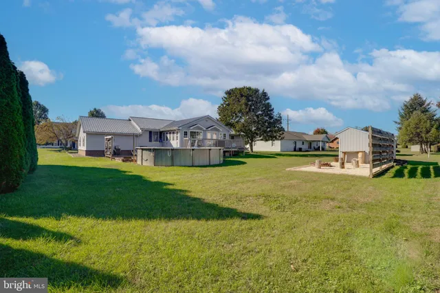 a view of a house with pool and a yard