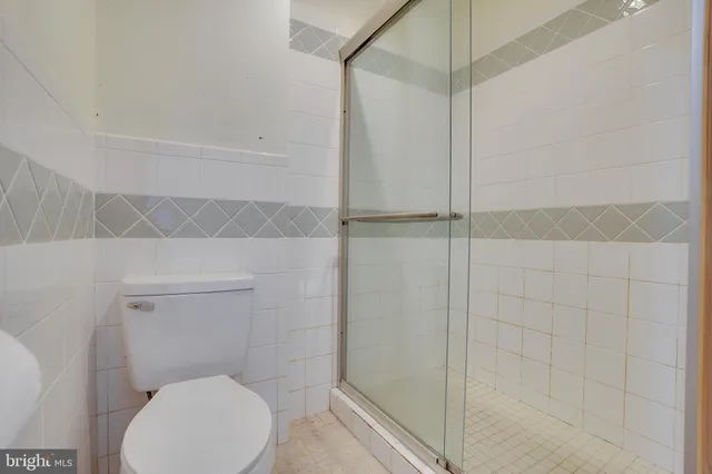a bathroom with a toilet and shower