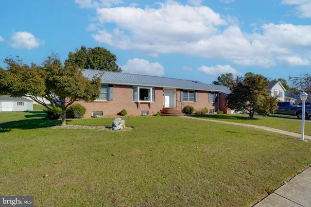 a front view of house with yard and trees
