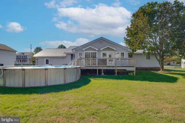 a view of a house with a yard and sitting area