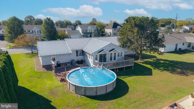 an aerial view of a house with swimming pool and big yard