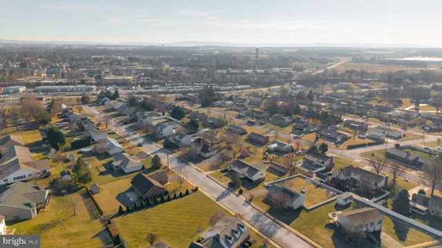 an aerial view of residential houses with city view