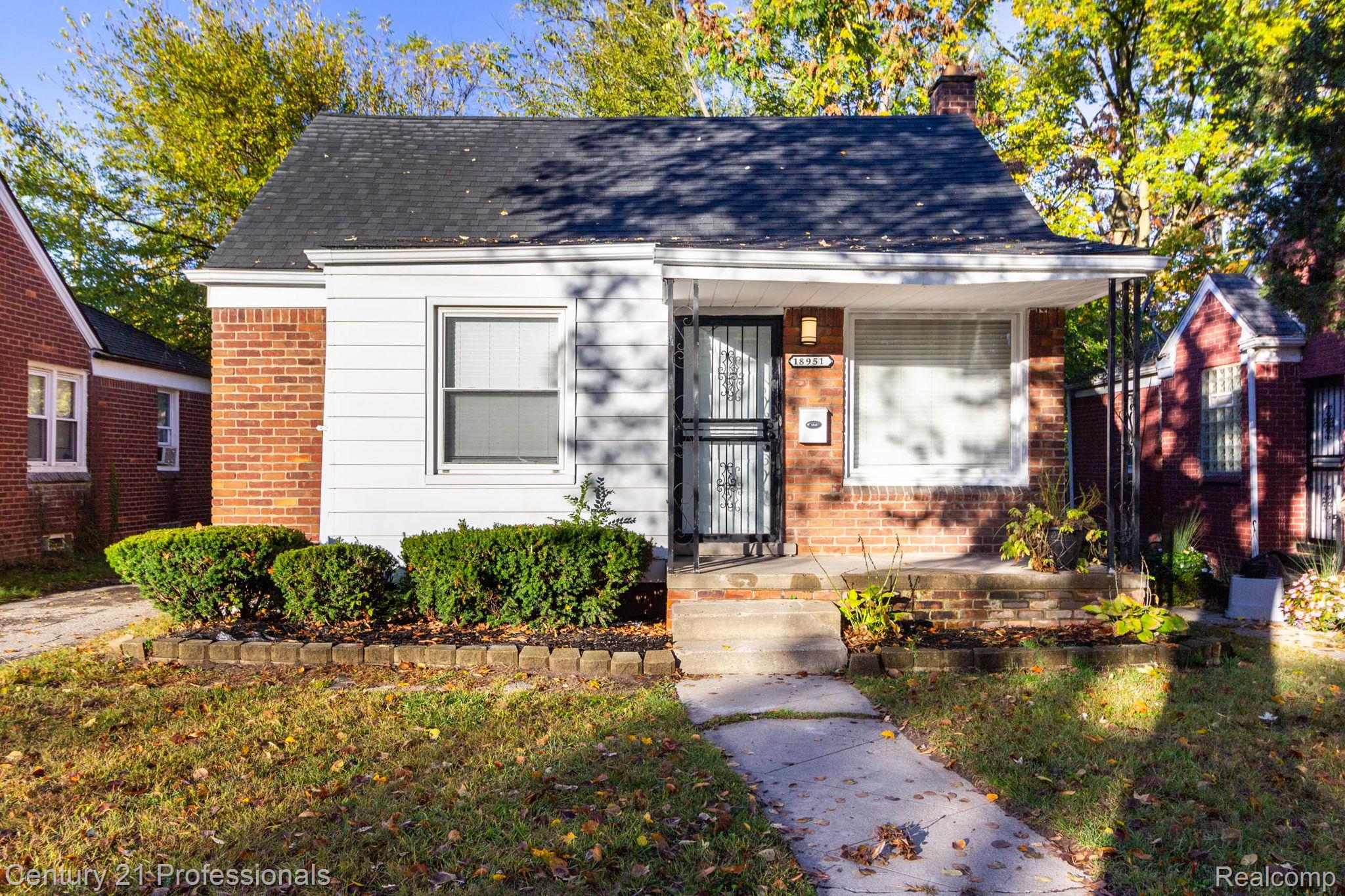 18951 Edinborough Road Detroit, MI 48219 - Photo 1 of 47 View of front of house with brick siding, a chimney, a front yard, and roof with shingles