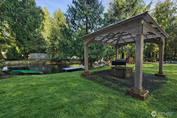 a view of a patio with a table chairs and a backyard