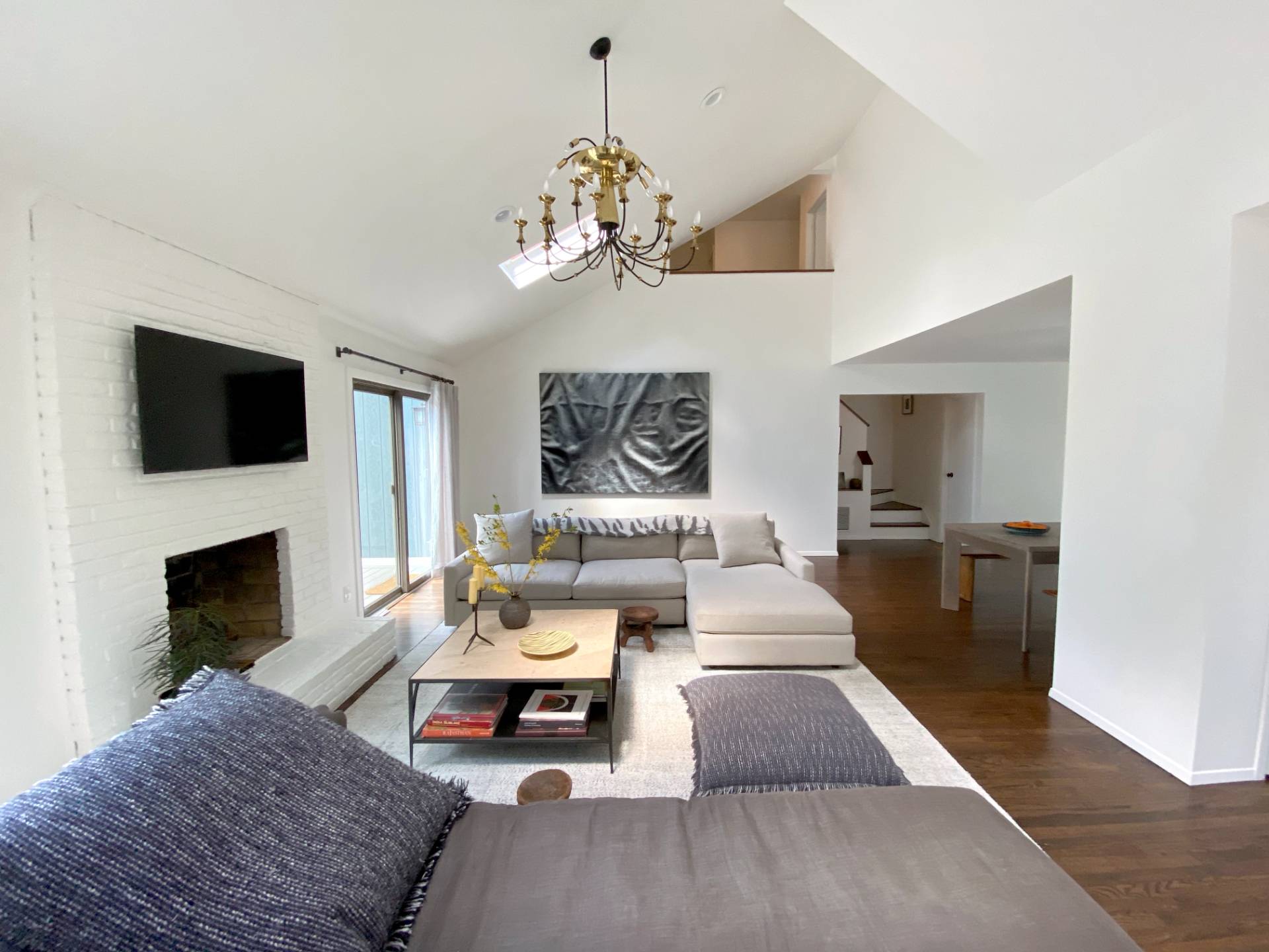4 Renees Way East Hampton, NY 11937 - Photo 2 of 16 a living room with furniture a fireplace and a chandelier