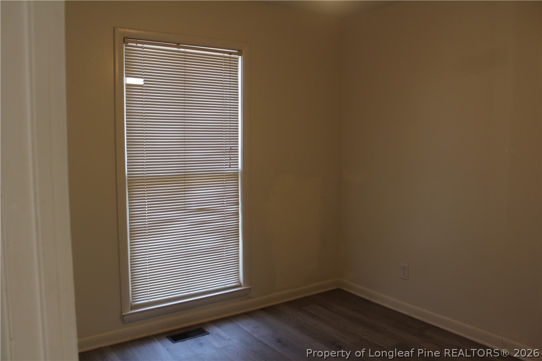3314 Arrowhead Road Spring Lake, NC 28390 - Photo 12 of 16 a view of an empty room with wooden floor and a window