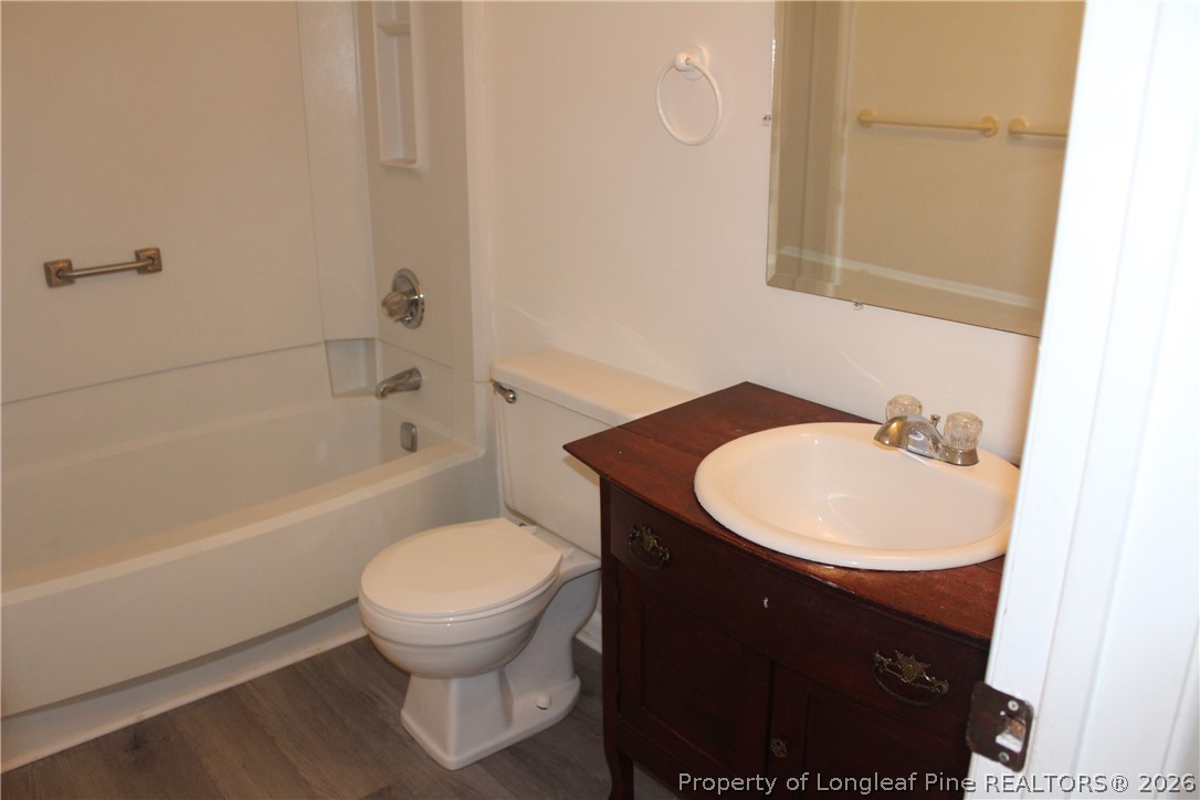 3314 Arrowhead Road Spring Lake, NC 28390 - Photo 15 of 16 a bathroom with a sink toilet and a bathtub