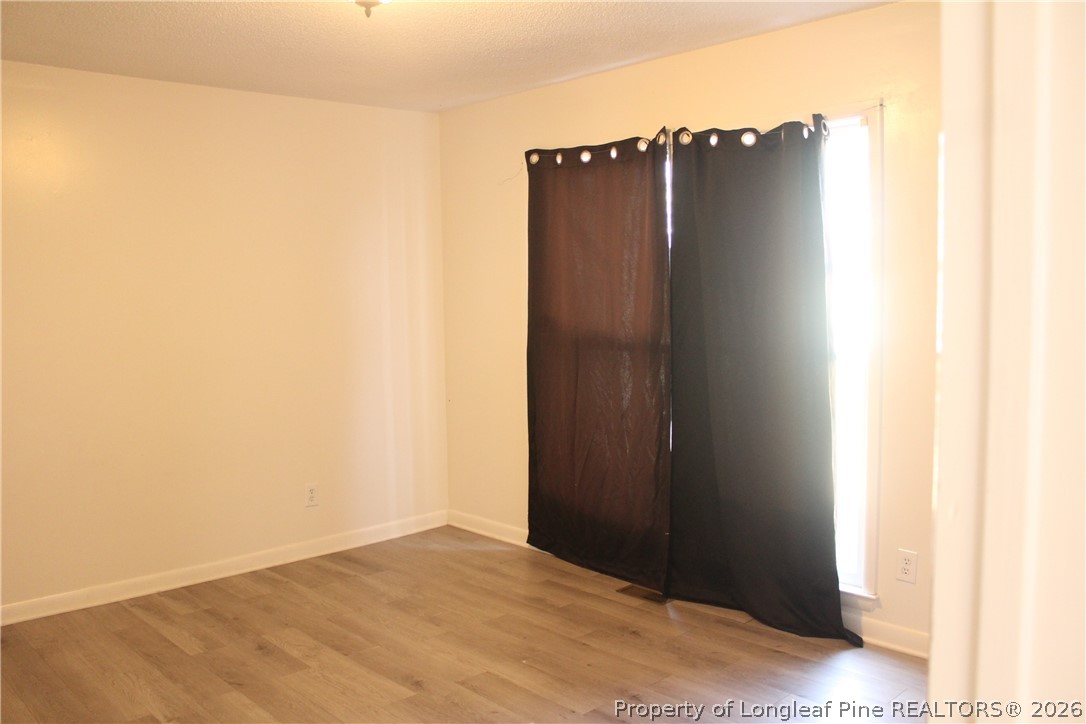 3314 Arrowhead Road Spring Lake, NC 28390 - Photo 8 of 16 an empty room with wooden floor