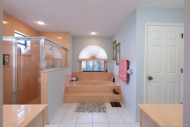 a bathroom with a tub shower and a sink
