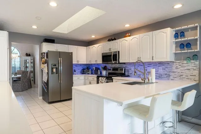 a kitchen with stainless steel appliances a refrigerator stove microwave and cabinets