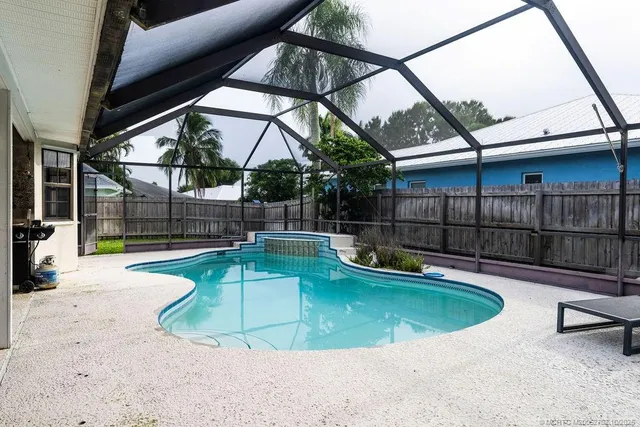 a view of a swimming pool with a patio