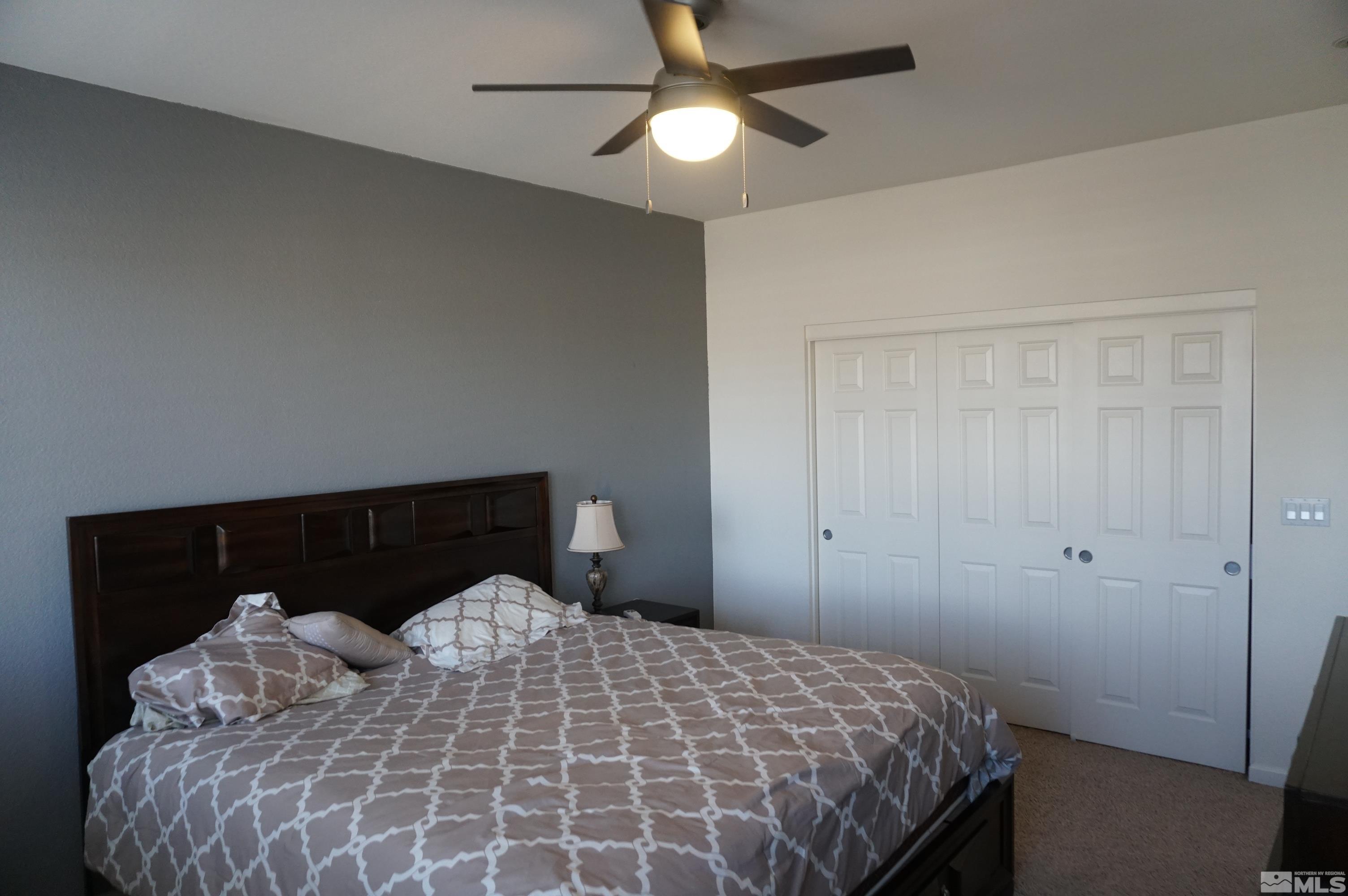 2120 Hellaby Lane Reno, NV 89502 - Photo 12 of 21 a bedroom with a bed and a chandelier