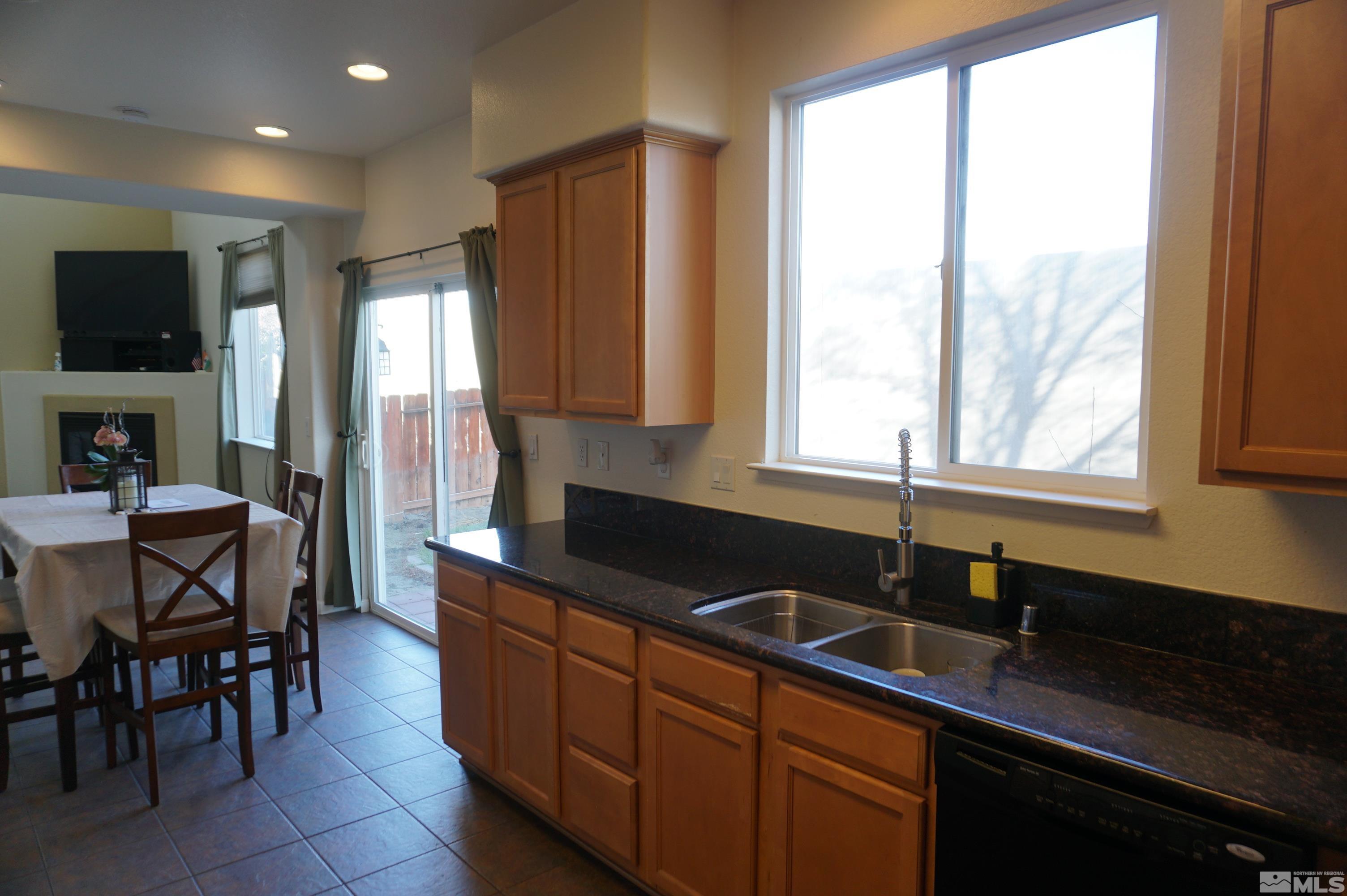 2120 Hellaby Lane Reno, NV 89502 - Photo 19 of 21 a kitchen with granite countertop a sink and a window