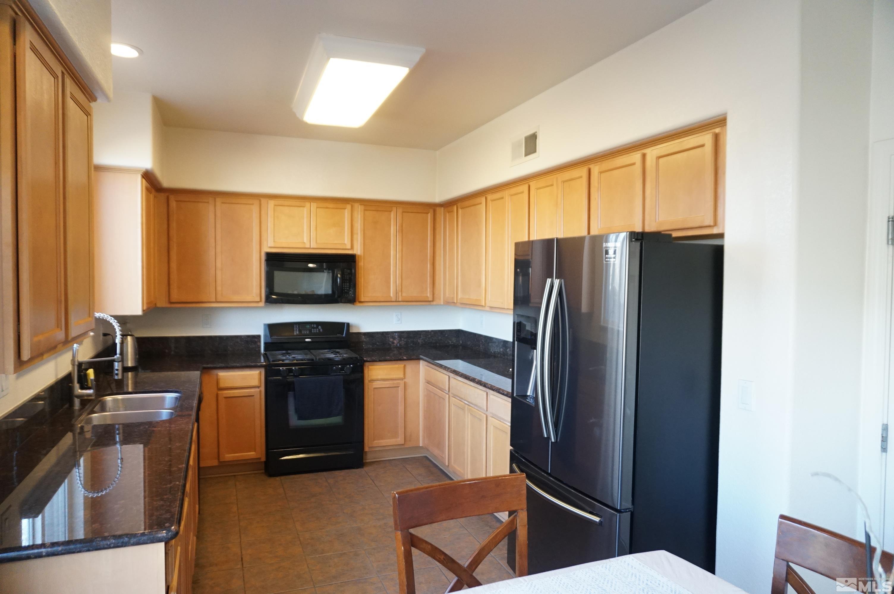 2120 Hellaby Lane Reno, NV 89502 - Photo 21 of 21 a kitchen with stainless steel appliances granite countertop a refrigerator stove and sink