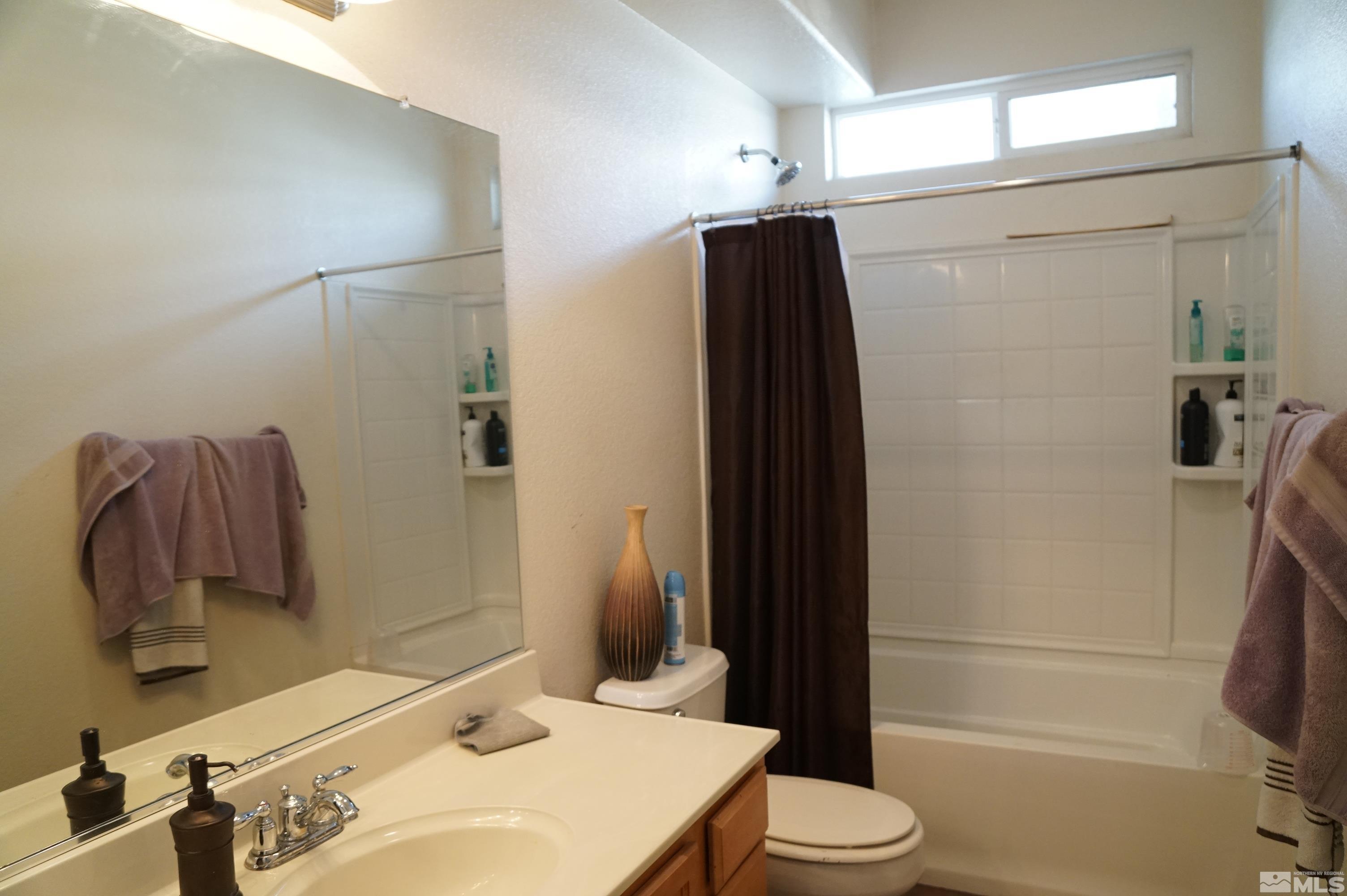 2120 Hellaby Lane Reno, NV 89502 - Photo 6 of 21 a bathroom with a sink and a mirror