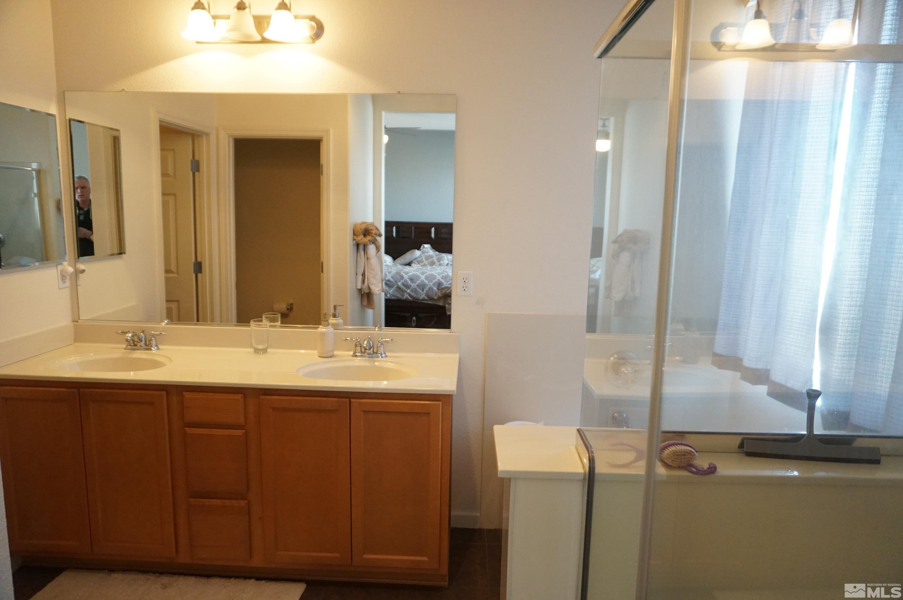 2120 Hellaby Lane Reno, NV 89502 - Photo 9 of 21 a bathroom with a double vanity sink and a mirror