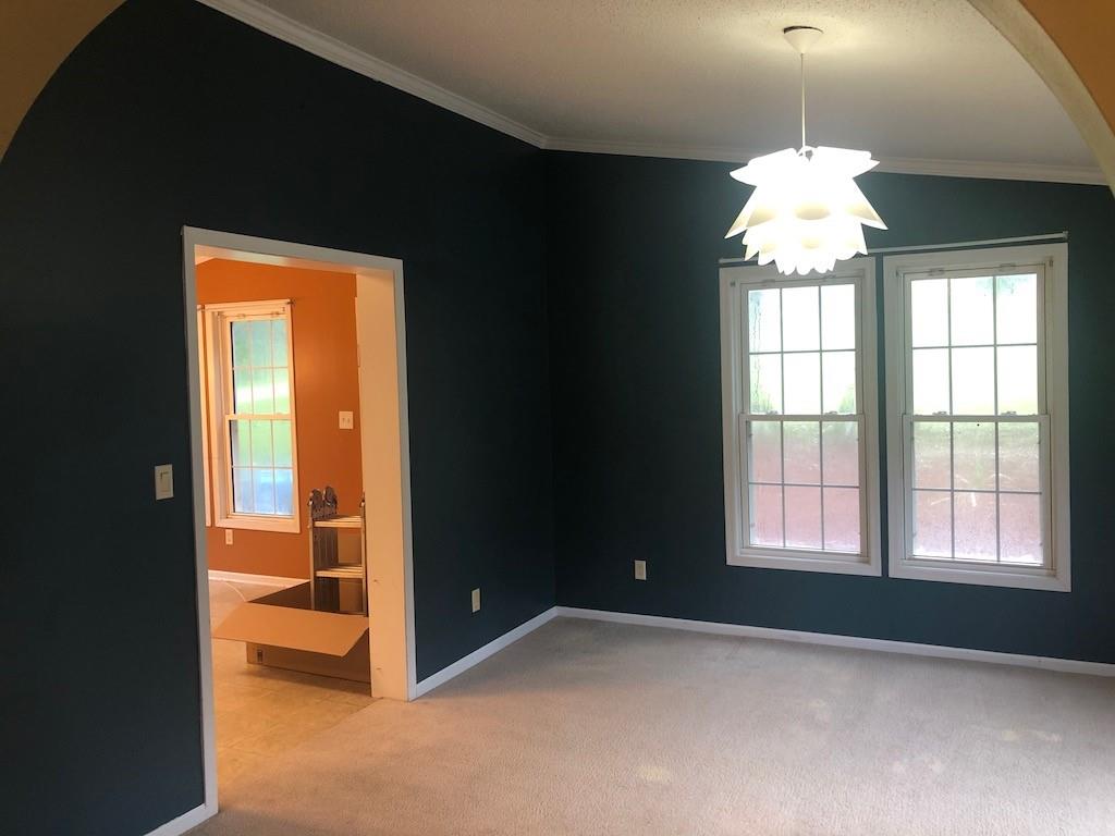 340 Ridge Road Mocksville, NC 27028 - Photo 13 of 22 a view of an empty room with window and chandelier fan