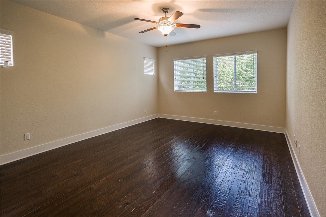 825 Clear Stream Crossing Austin, TX 78753 - Photo 19 of 34 a view of an empty room with wooden floor and a window
