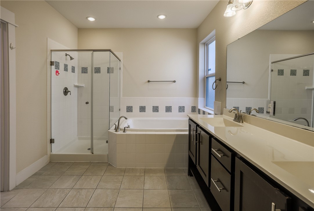 825 Clear Stream Crossing Austin, TX 78753 - Photo 21 of 34 a spacious bathroom with a tub sink and mirror