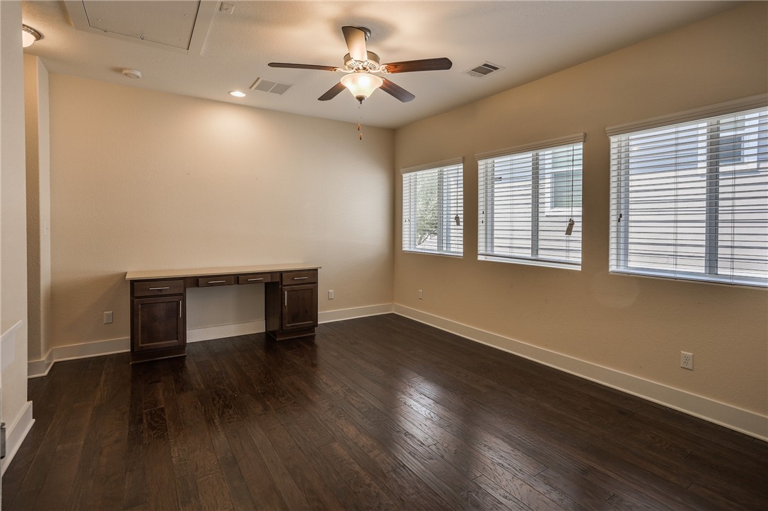 825 Clear Stream Crossing Austin, TX 78753 - Photo 24 of 34 an empty room with wooden floor and windows