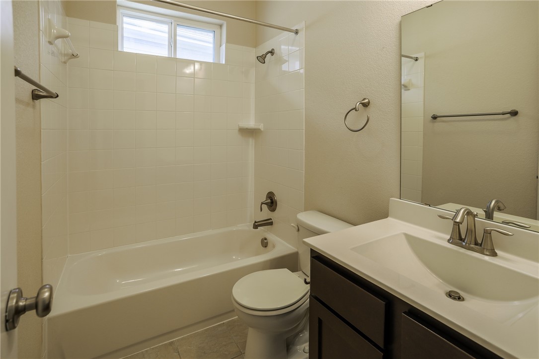 825 Clear Stream Crossing Austin, TX 78753 - Photo 26 of 34 a bathroom with a sink a toilet and shower