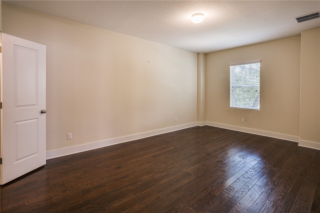 825 Clear Stream Crossing Austin, TX 78753 - Photo 27 of 34 an empty room with wooden floor and window
