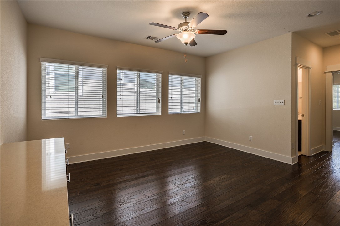 825 Clear Stream Crossing Austin, TX 78753 - Photo 28 of 34 a view of an empty room with wooden floor and a window