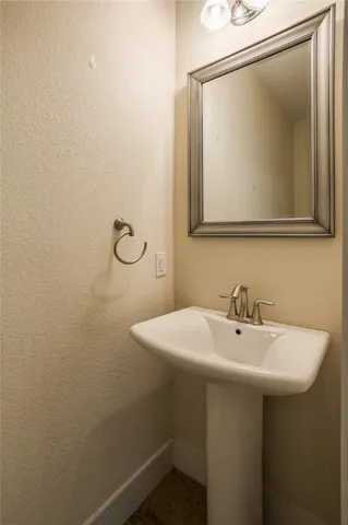 a bathroom with a sink and mirror