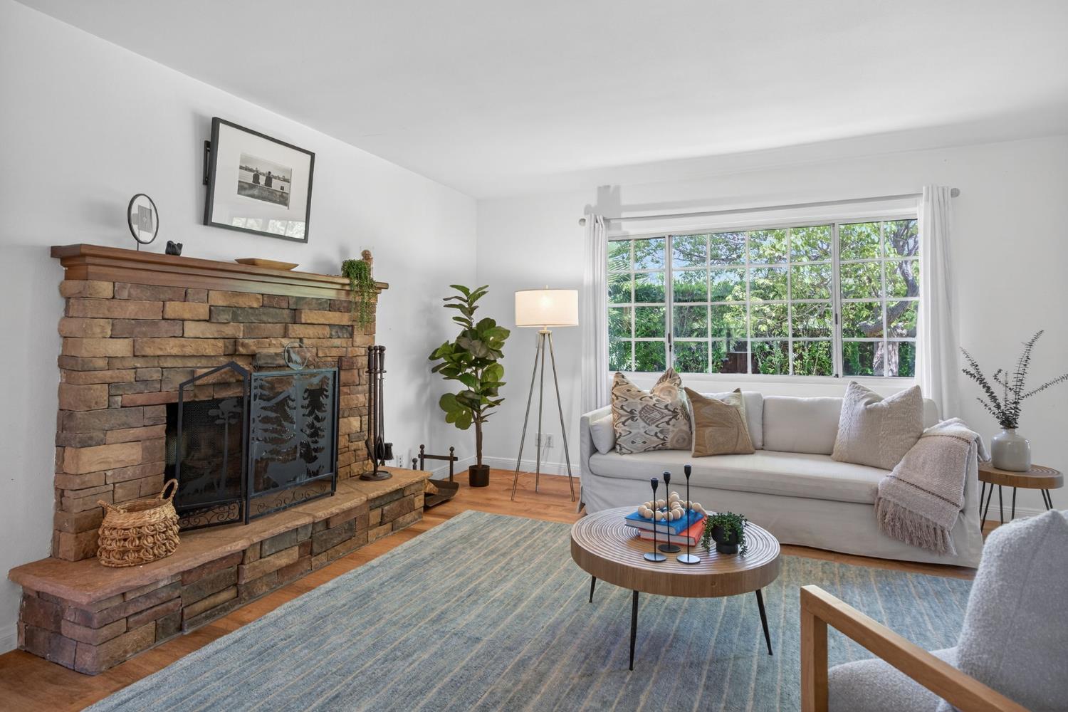 1054 Fairview Road Ojai, CA 93023 - Photo 11 of 33 a living room with furniture a fireplace and a large window