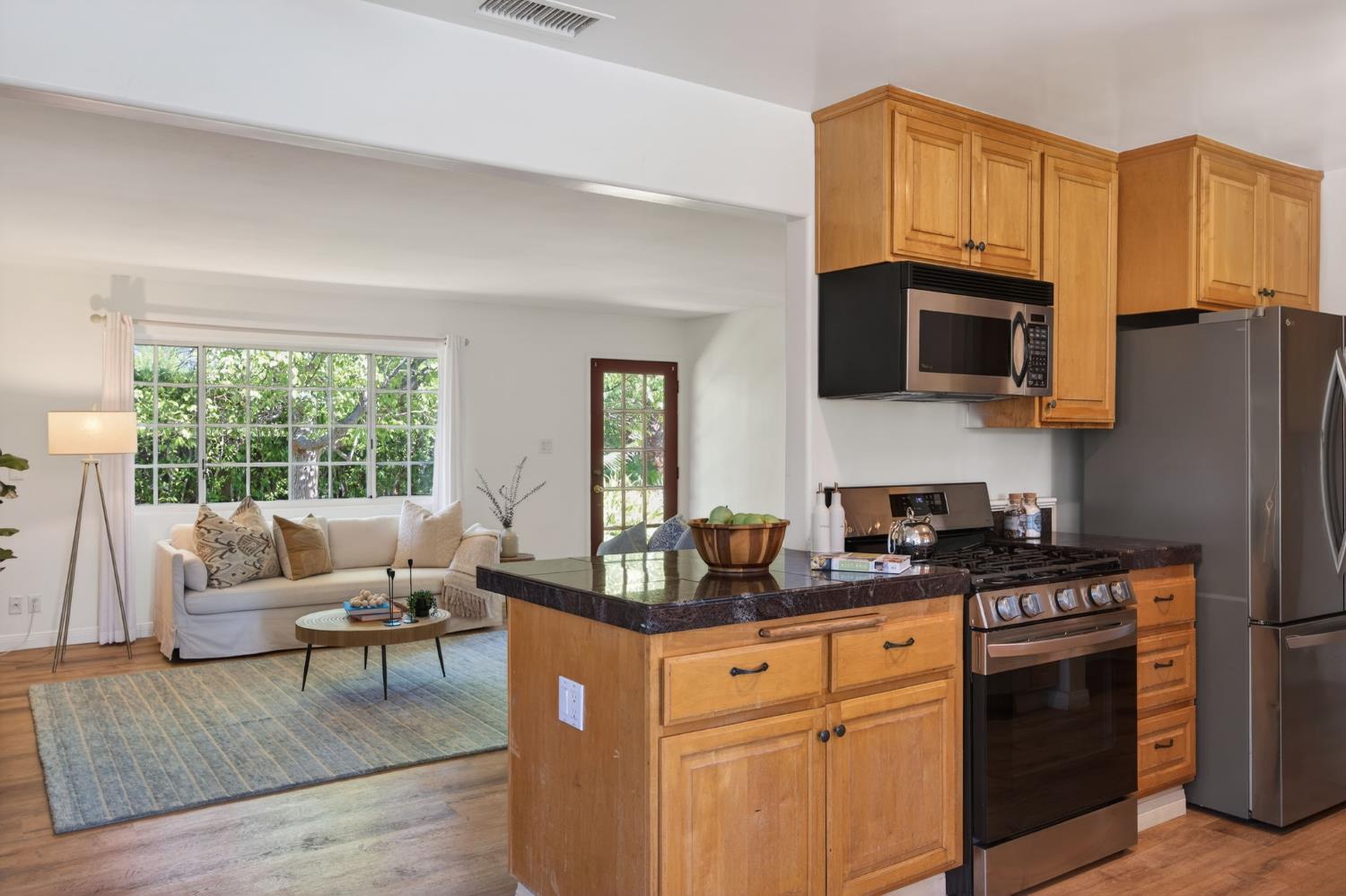 1054 Fairview Road Ojai, CA 93023 - Photo 14 of 33 a kitchen with stainless steel appliances granite countertop a stove a sink dishwasher a microwave oven and a refrigerator with wooden floor