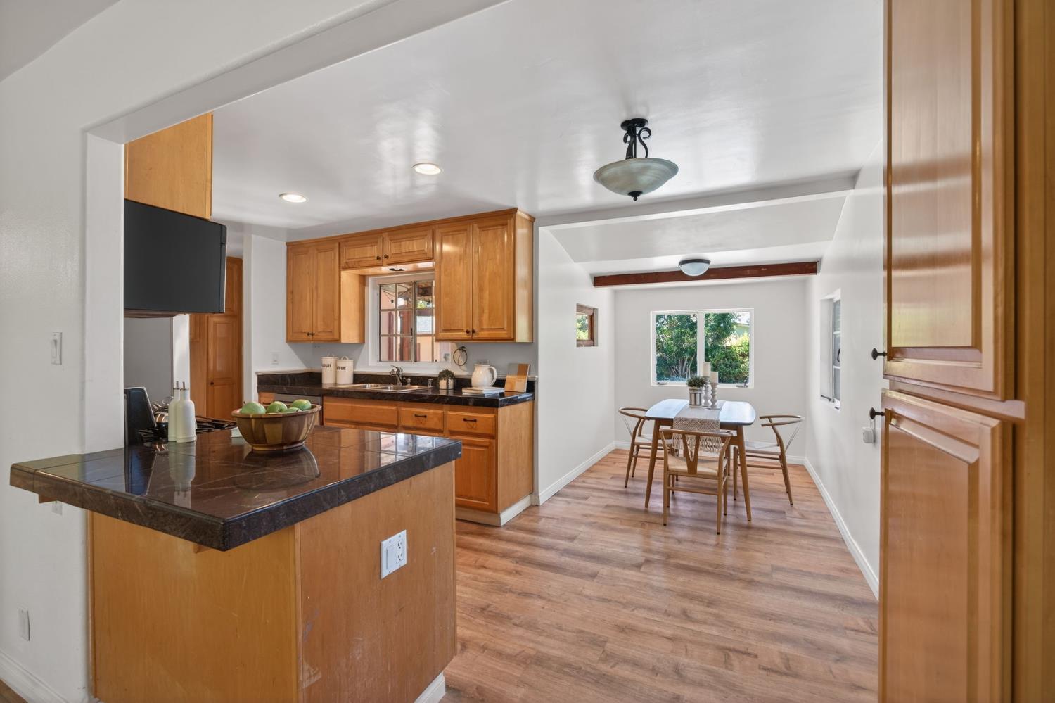1054 Fairview Road Ojai, CA 93023 - Photo 15 of 33 a dining hall with granite countertop a refrigerator dining table and chairs