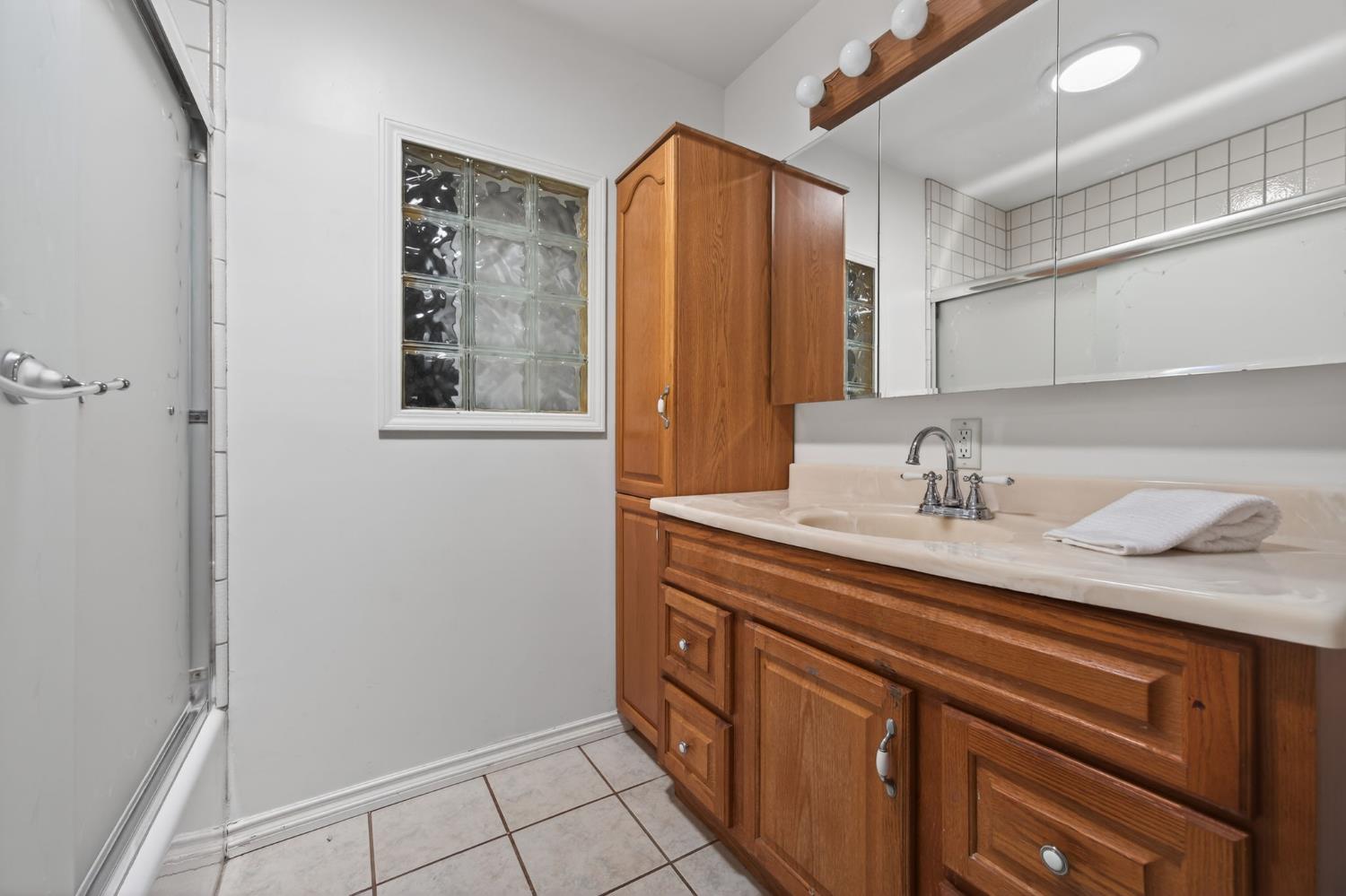 1054 Fairview Road Ojai, CA 93023 - Photo 27 of 33 a bathroom with a granite countertop sink and a mirror