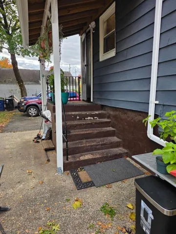 a view of path along with house and car parked